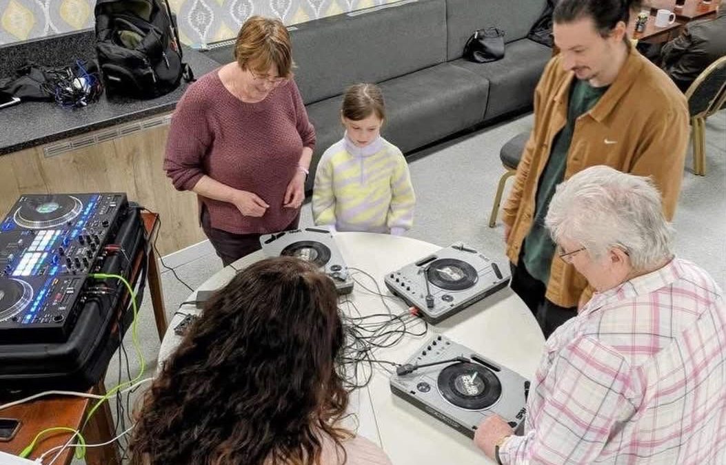 Chatty Café attendees exploring DJing and graffiti art in Prescot